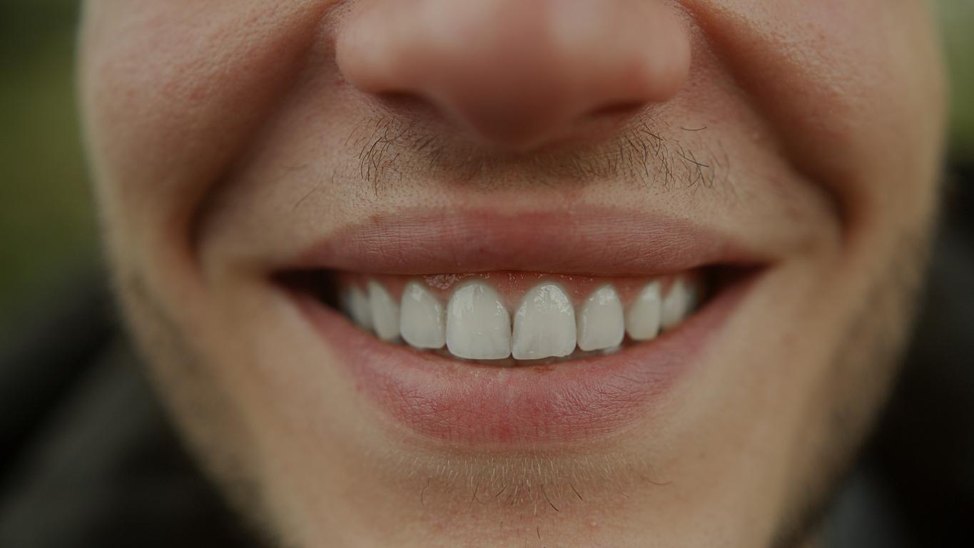 Closeup of man's face showing off his perfect teeth
