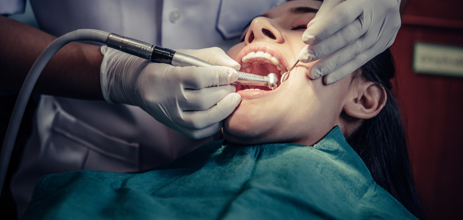 Dentist performing emergency dental crown treatment on a patient in the chair