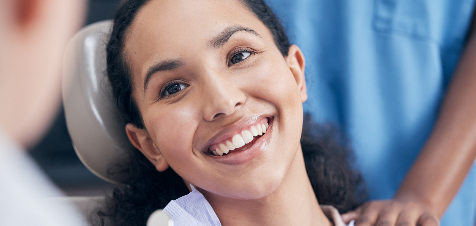 Smiling patient in the dental chair during a full mouth reconstruction visit