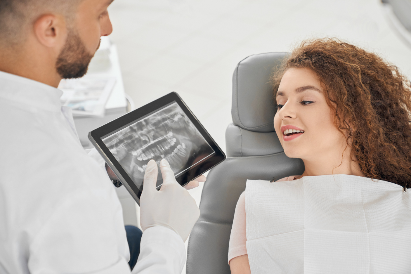 Dentist reviewing X-ray to assess the condition of a dental crown at Art of Modern Dentistry Chicago
