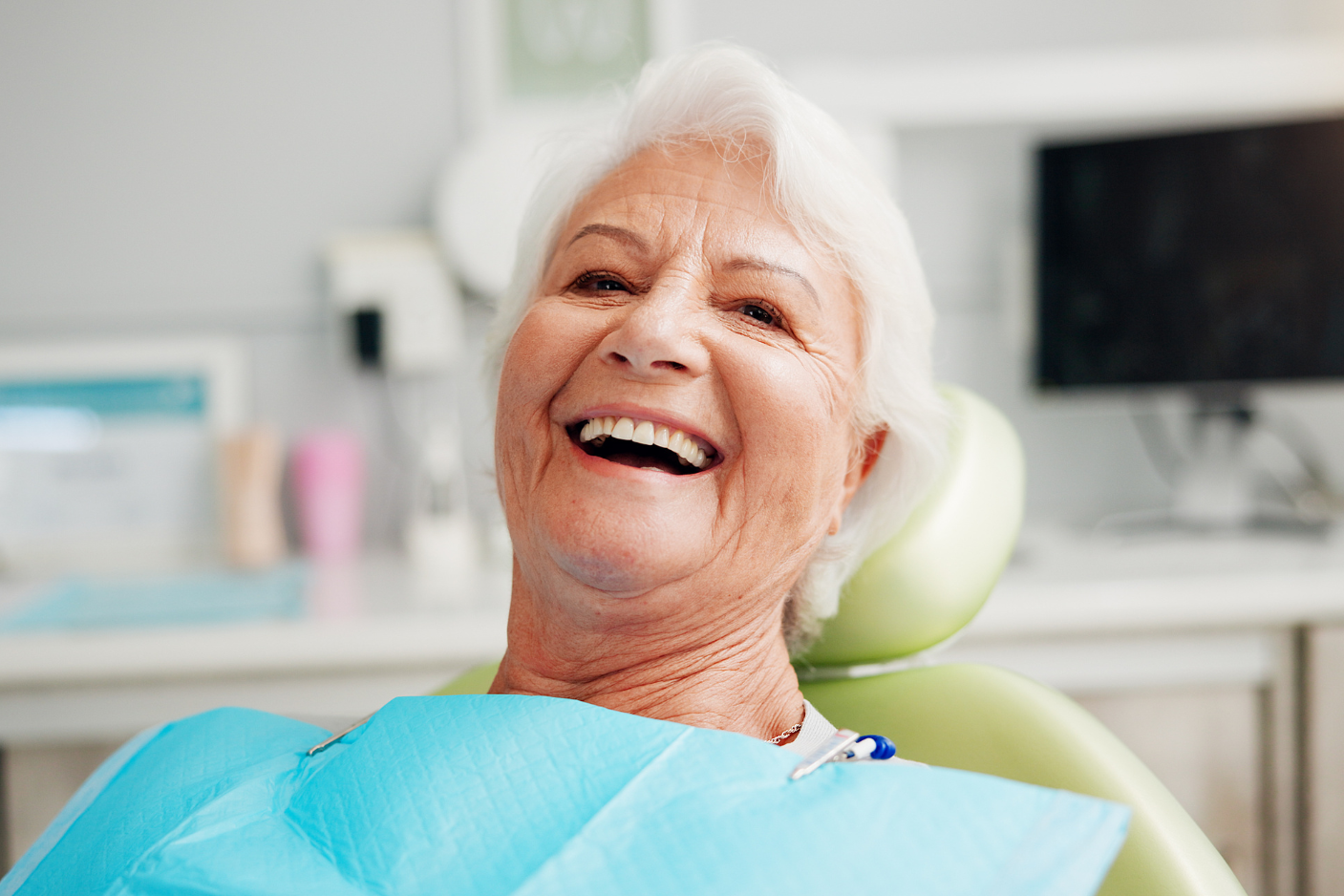 Senior woman smiling confidently after dental implants at Art of Modern Dentistry Chicago
